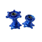 Blue anodized aluminum Sur Ron Ultra Bee 18-inch wheel hub with six spokes