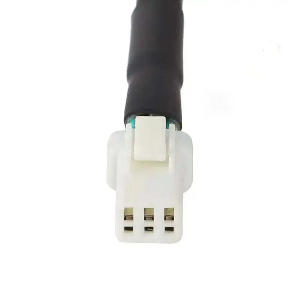White plastic Sur-Ron Ultra Bee taillight connector with black cable and green stripe